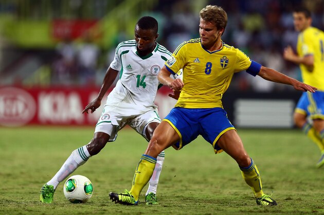 DUBAI, UNITED ARAB EMIRATES - NOVEMBER 05: Chhidiebere Nwakali (L) Elias Andersson and during the FIFA U-17 World cup UAE 2013 Semi Final match between  Sweden and Nigeria at Al Rashid Stadium on November 5, 2013 in Dubai, United Arab Emirates.  (Photo by Amin Mohammad Jamali/Getty Images)