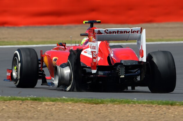 NORTHAMPTON, ENGLAND - JUNE 30:  Felipe Massa of Brazil and Ferrari has a left rear puncture on his tyre during the British Formula One Grand Prix at Silverstone Circuit on June 30, 2013 in Northampton, England.  (Photo by Lars Baron/Getty Images)