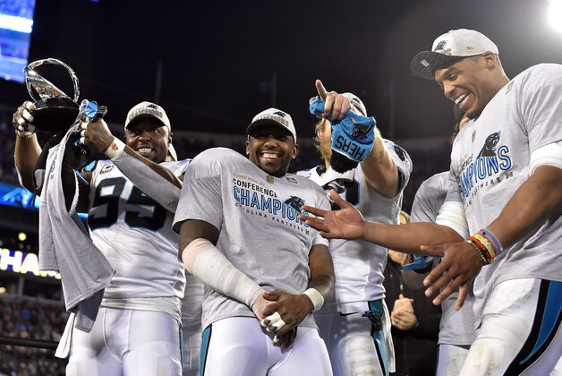 Jan 24, 2016; Charlotte, NC, USA; Carolina Panthers defensive end Charles Johnson (95), outside linebacker Thomas Davis (58), tight end Greg Olsen (88) and quarterback Cam Newton (1) celebrates with the George Halas Trophy after beating the Arizona Cardinals in the NFC Championship football game at Bank of America Stadium. Mandatory Credit: Bob Donnan-USA TODAY Sports