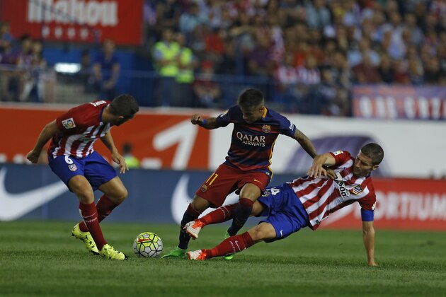 Barcelona's Neymar, center, tussles for the ball with Atletico Madrid's Jorge Resurrecion “Koke”, left, and Gabriel Fernandez “Gabi” during a Spanish La Liga soccer match between Atletico Madrid and Barcelona at the Vicente Calderon stadium in Madrid, Saturday, Sept. 12, 2015. (AP Photo/Francisco Seco)