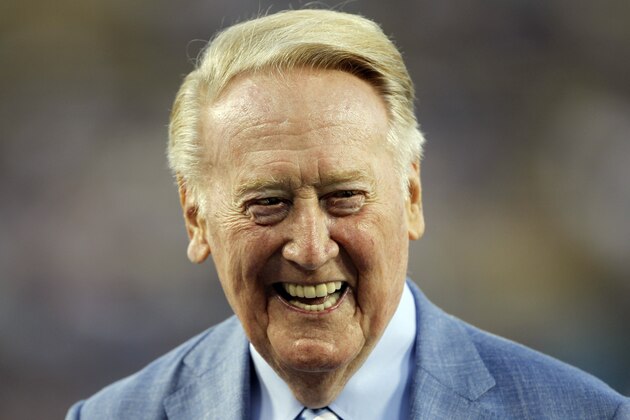 Los Angeles Dodgers broadcaster Vin Scully is honored before a baseball game against the Arizona Diamondbacks in Los Angeles, Wednesday, Sept. 23, 2015. Scully was given a Guinness World Records certificate for the longest career as a sports broadcaster for a single team, and the team honored him with a bobble head for all of the fans in attendance. (AP Photo/Alex Gallardo)
