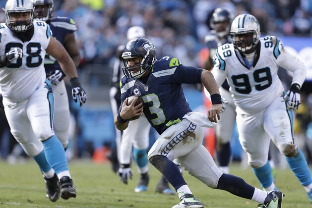 Seattle Seahawks quarterback Russell Wilson (3) works against the Carolina Panthers during the first half of an NFL divisional playoff football game, Sunday, Jan. 17, 2016, in Charlotte, N.C. (AP Photo/Bob Leverone)