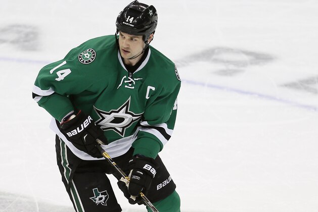 Dallas Stars forward Jamie Benn (14) plays the puck during the first period of an NHL hockey game against the Colorado Avalanche Saturday, January 23, 2016, in Dallas. Colorado won 3-1. (AP Photo/Brandon Wade)