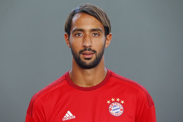 Bayern’s Medhi Benatia from Morocco poses during an official photo shooting for the upcoming German first division Bundesliga soccer season in Munich, Germany, on Thursday, July 16, 2015. (AP Photo/Matthias Schrader)