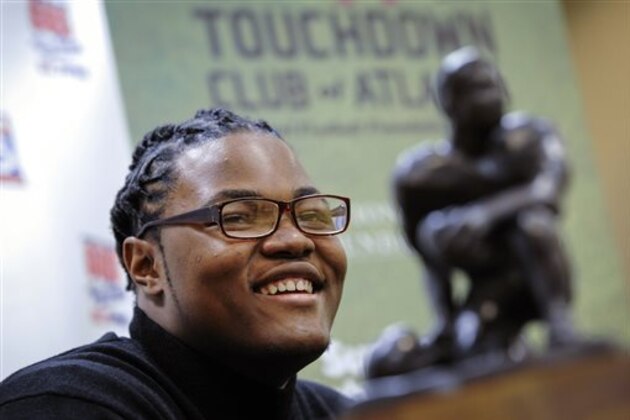 FILE - In this Thursday, Jan. 28, 2016, file photo, Rashan Gary, of Paramus, N.J., talks to members of the media in Atlanta, while on hand to receive the Bobby Dodd national high school lineman of the year award at the Touchdown Club of Atlanta. The defensive tackle from Paramus Catholic High School in New Jersey and most-wanted recruit in the country is weighing whether to play for one of those Southern power programs such as Alabama and Clemson or head to Michigan to be part of the Wolverines' rebirth under Jim Harbaugh. (AP Photo/John Amis, File)