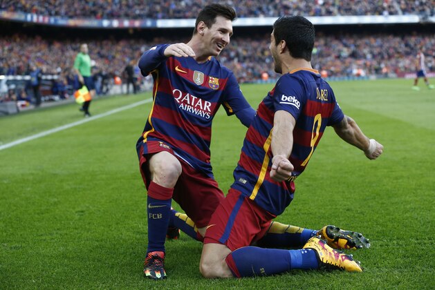 FC Barcelona's Luis Suarez, right, reacts after scoring with his teammate Lionel Messi against Atletico Madrid during a Spanish La Liga soccer match at the Camp Nou stadium in Barcelona, Spain, Saturday, Jan. 30, 2016. (AP Photo/Manu Fernandez)