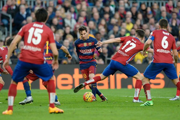 Barcelona's Argentinian forward Lionel Messi (2ndL) controls the ball during the Spanish league football match FC Barcelona vs Club Atletico de Madrid at the Camp Nou stadium in Barcelona on January 30, 2016. Barcelona won 2-1.   AFP PHOTO/ JOSEP LAGO / AFP / JOSEP LAGO        (Photo credit should read JOSEP LAGO/AFP/Getty Images)