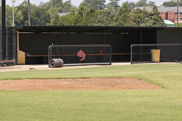 This photo shows an empty dugout on the baseball field at East Central University in Ada, Okla., Wednesday, Aug. 21, 2013.  Australian Christopher Lane, who was on a baseball scholarship at East Central University was in Duncan, Okla., visiting his girlfriend, when he was shot and killed. (AP Photo/Sue Ogrocki)