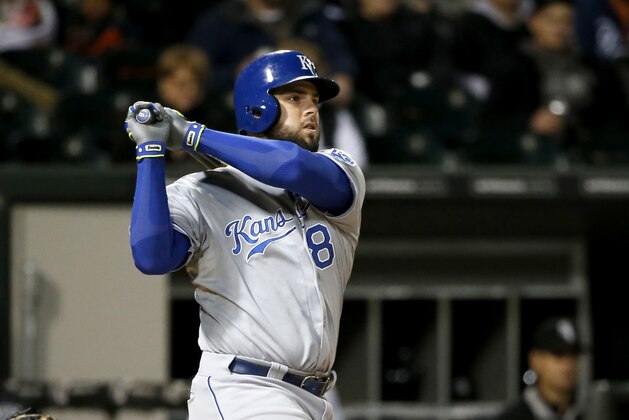 Kansas City Royals' Mike Moustakas watches his two-run home run off Chicago White Sox starting pitcher Jose Quintana, also scoring Kendrys Morales, during the sixth inning of a baseball game Wednesday, Sept. 30, 2015, in Chicago. (AP Photo/Charles Rex Arbogast)