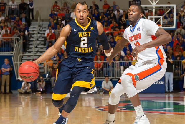West Virginia guard Jevon Carter (2) dribbles past Florida forward Dorian Finney-Smith (10) during the first half of an NCAA college basketball game, Saturday, Jan. 30, 2016, in Gainesville, Fla. (AP Photo/Ronald Irby) West Virginia guard Jevon Carter (2) dribbles past Florida forward Dorian Finney-Smith (10) during the first half of an NCAA college basketball game, Saturday, Jan. 30, 2016, in Gainesville, Fla. (AP Photo/Ronald Irby)