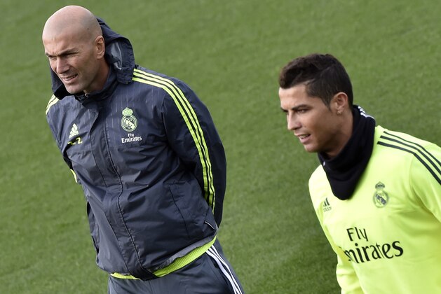Real Madrid's new French coach Zinedine Zidane (L) and Real Madrid's Portuguese forward Cristiano Ronaldo take part in a training session at the Valdebebas training ground in Madrid on January 8, 2016.   AFP PHOTO / GERARD JULIEN / AFP / GERARD JULIEN        (Photo credit should read GERARD JULIEN/AFP/Getty Images)