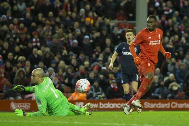 Liverpool's Christian Benteke, right, has a shot blocked by West Ham's Darren Randolph during the English FA Cup fourth-round soccer match between Liverpool and West Ham United at Anfield Stadium, Liverpool, England, Saturday Jan. 30, 2016. (AP Photo/Jon Super)