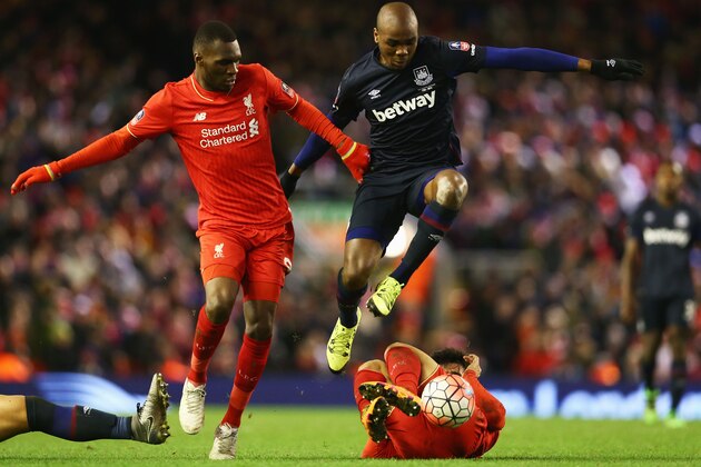 LIVERPOOL, ENGLAND - JANUARY 30:  Angelo Ogbonna Obinza of West Ham United battles with Christian Benteke (L) and Joao Carlos Teixeira of Liverpool (R) during the Emirates FA Cup Fourth Round match between Liverpool and West Ham United at Anfield on January 30, 2016 in Liverpool, England.  (Photo by Clive Brunskill/Getty Images)