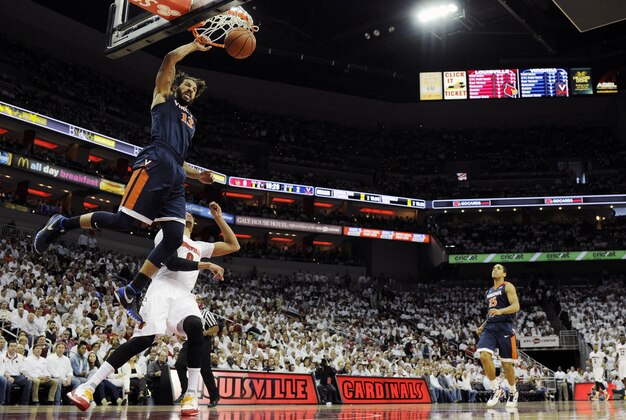 Jan 30, 2016; Louisville, KY, USA; Virginia Cavaliers forward Anthony Gill (13) dunks against Louisville Cardinals guard Damion Lee (0) during the first half at KFC Yum! Center. Mandatory Credit: Jamie Rhodes-USA TODAY Sports