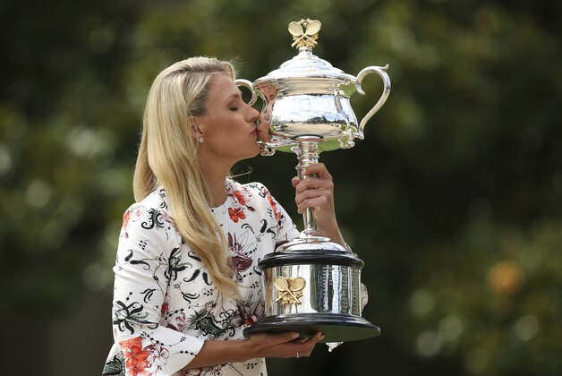 Germany's Angelique Kerber kisses her trophy during a photo shoot with her Australian Open trophy at Government House in Melbourne, Australia, Sunday, Jan. 31, 2016. Kerber defeated Serena Williams of the United States in the women's final at the Australian Open tennis championships on Saturday, Jan. 30.(AP Photo/Rick Rycroft)