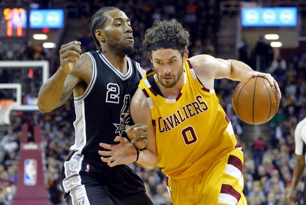 Jan 30, 2016; Cleveland, OH, USA; Cleveland Cavaliers forward Kevin Love (0) drives against San Antonio Spurs forward Kawhi Leonard (2) in the first quarter at Quicken Loans Arena. Mandatory Credit: David Richard-USA TODAY Sports