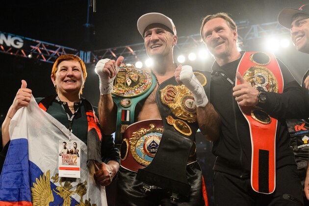 MONTREAL, QC - JANUARY 30:  Sergey Kovalev of Russia (centre) poses for photos with his mom and with former NHL player Alexei Kovalev during the WBO, WBA, and IBF light heavyweight world championship match at the Bell Centre on January 30, 2016 in Montreal, Quebec, Canada.  (Photo by Minas Panagiotakis/Getty Images)