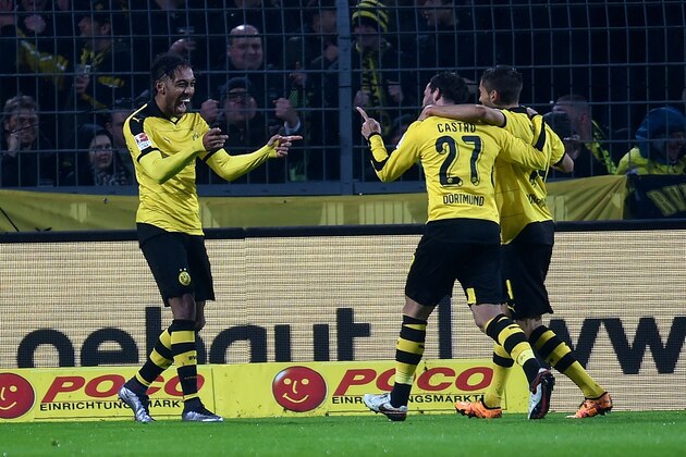 Dortmund's Gabonese striker Pierre-Emerick Aubameyang (L) celebrates with his teammates during the German first division Bundesliga football match of Borussia Dortmund vs FC Ingolstadt 04 in Dortmund, western Germany, on January 30, 2016. 
Dortmund won the match 2-0. / AFP / PATRIK STOLLARZ / RESTRICTIONS: DURING MATCH TIME: DFL RULES TO LIMIT THE ONLINE USAGE TO 15 PICTURES PER MATCH AND FORBID IMAGE SEQUENCES TO SIMULATE VIDEO. == RESTRICTED TO EDITORIAL USE == FOR FURTHER QUERIES PLEASE CONTACT DFL DIRECTLY AT + 49 69 650050
        (Photo credit should read PATRIK STOLLARZ/AFP/Getty Images)