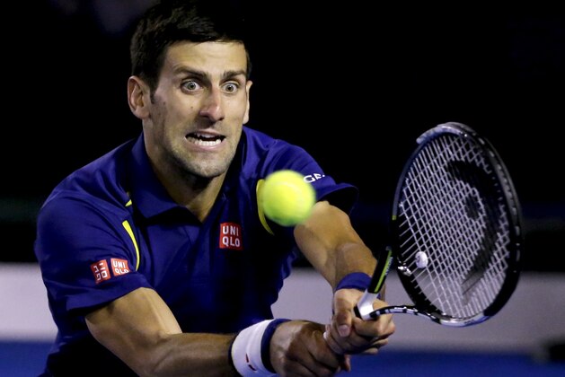 Novak Djokovic of Serbia plays a backhand return to Andy Murray of Britain during the men's singles final at the Australian Open tennis championships in Melbourne, Australia, Sunday, Jan. 31, 2016.(AP Photo/Aaron Favila)