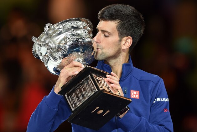 Serbia's Novak Djokovic kisses The Norman Brookes Challenge Cup after his victory during the men's singles final against Britain's Andy Murray on day 14 of the 2016 Australian Open tennis tournament in Melbourne on January 31, 2016. AFP PHOTO / PETER PARKS -- IMAGE RESTRICTED TO EDITORIAL USE - STRICTLY NO COMMERCIAL USE / AFP / PETER PARKS        (Photo credit should read PETER PARKS/AFP/Getty Images)