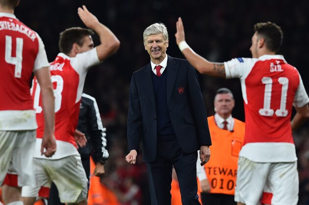 Arsenal's French manager Arsene Wenger (C) watches as Arsenal's German midfielder Mesut Ozil (R) celebrates scoring his team's second goal with teamamte Arsenal's Spanish defender Nacho Monreal during the UEFA Champions League football match between Arsenal and Bayern Munich at the Emirates Stadium in London, on October 20, 2015.  Arsenal won the match 2-0.  AFP PHOTO / BEN STANSALL        (Photo credit should read BEN STANSALL/AFP/Getty Images)