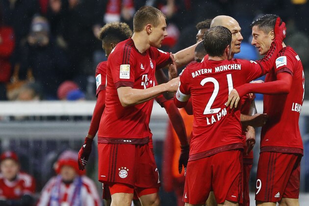Bayern's Robert Lewandowski, right, celebrates with teammates after scoring his side's opening goal during the German Bundesliga soccer match between FC Bayern Munich and TSG 1899 Hoffenheim at the Allianz Arena stadium in Munich, Germany, Sunday, Jan. 31, 2016. (AP Photo/Matthias Schrader)
