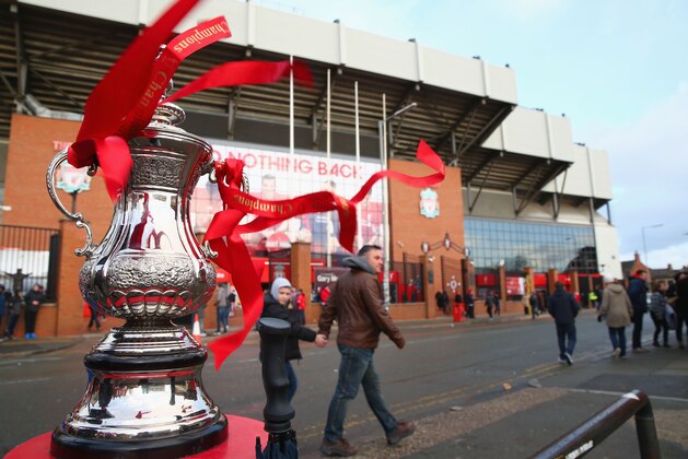 LIVERPOOL, ENGLAND - JANUARY 30:  Fans walk past the FA Cup trophy outside the stadium during the Emirates FA Cup Fourth Round match between Liverpool and West Ham United at Anfield on January 30, 2016 in Liverpool, England.  (Photo by Clive Brunskill/Getty Images)