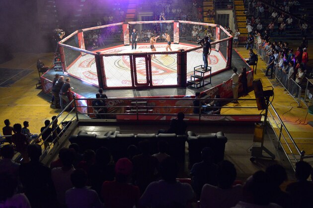 TO GO WITH AFP STORY: Cambodia-lifestyle-sport-MMA,FEATURE by Suy SE
This photo taken on August 24, 2014 shows a general view of a Cambodian cage fight for a local television (TV) programme at a statium in Phnom Penh. He is schooled in ancient Cambodian martial arts, but Tok Sophon hopes to turn his pugilism skills into wealth and international glory in the modern cage-fighting arena -- a transition some fighters fear will wipe out their craft.     AFP PHOTO/TANG CHHIN SOTHY        (Photo credit should read TANG CHHIN SOTHY/AFP/Getty Images)