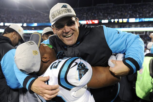 Carolina Panthers head coach Ron Rivera celebrates with Jonathan Stewart after the NFL football NFC Championship game against the Arizona Cardinals, Sunday, Jan. 24, 2016, in Charlotte, N.C. The Panthers won 49-15 to advance to the Super Bowl. (AP Photo/Mike McCarn)