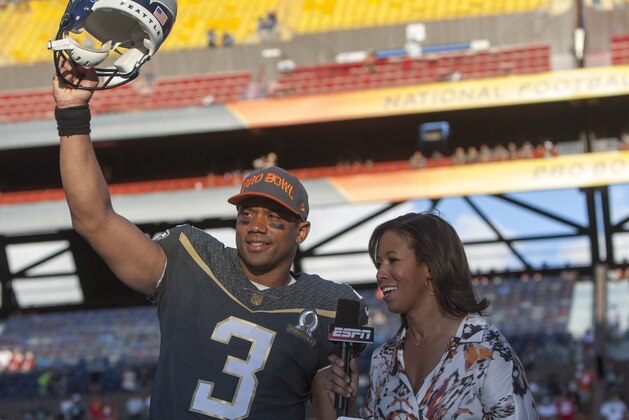 Seattle Seahawks quarterback Russell Wilson (3) of Team Irvin reacts after winning offensive MVP award while being interviewed by ESPN sideline reporter Lisa Salters at the NFL Pro Bowl football game Sunday, Jan. 31, 2016, in Honolulu. Team Irving beat Team Rice 49-27. (AP Photo/Marco Garcia)