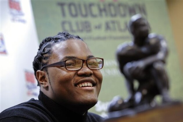FILE - In this Thursday, Jan. 28, 2016, file photo, Rashan Gary, of Paramus, N.J., talks to members of the media in Atlanta, while on hand to receive the Bobby Dodd national high school lineman of the year award at the Touchdown Club of Atlanta. The defensive tackle from Paramus Catholic High School in New Jersey and most-wanted recruit in the country is weighing whether to play for one of those Southern power programs such as Alabama and Clemson or head to Michigan to be part of the Wolverines' rebirth under Jim Harbaugh. (AP Photo/John Amis, File)