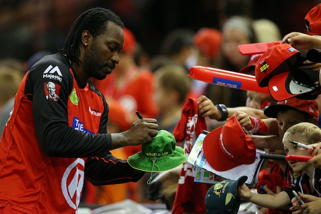 MELBOURNE, AUSTRALIA - JANUARY 18:  Chris Gayle of the Renegades signs his autograph for fans during the Big Bash League match between the Melbourne Renegades and the Adelaide Strikers at Etihad Stadium on January 18, 2016 in Melbourne, Australia.  (Photo by Graham Denholm/Getty Images)