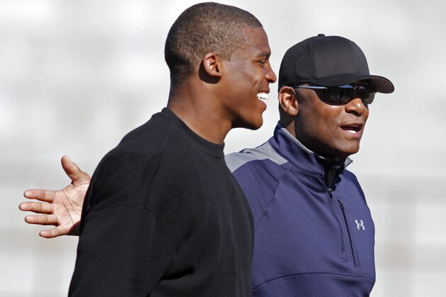 NFL draft prospect Cam Newton shares a laugh with former NFL quarterback Warren Moon, right, during a football workout Thursday, Feb. 10, 2011, in San Diego. (AP Photo/Chris Park)