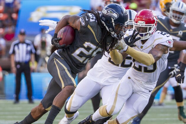 Seattle Seahawks cornerback Richard Sherman (25) of Team Irvin attempts to stiff-arm Kansas City Chiefs safety Eric Berry (29) of Team Rice in the third quarter of the NFL Pro Bowl football game, Sunday, Jan. 31, 2016, in Honolulu. (AP Photo/Eugene Tanner)