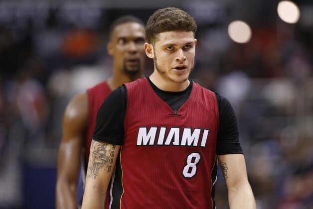 Miami Heat guard Tyler Johnson (8) and Miami Heat forward Chris Bosh, back, head to the bench in the second half of an NBA basketball game against the Washington Wizards, Wednesday, Jan. 20, 2016, in Washington. The Wizards won 106-87. (AP Photo/Alex Brandon)