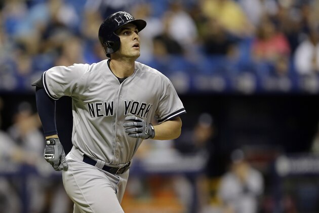 New York Yankees' Greg Bird watches his home run off Tampa Bay Rays relief pitcher Andrew Bellatti during the ninth inning of a baseball game Wednesday, Sept. 16, 2015, in St. Petersburg, Fla.  (AP Photo/Chris O'Meara)