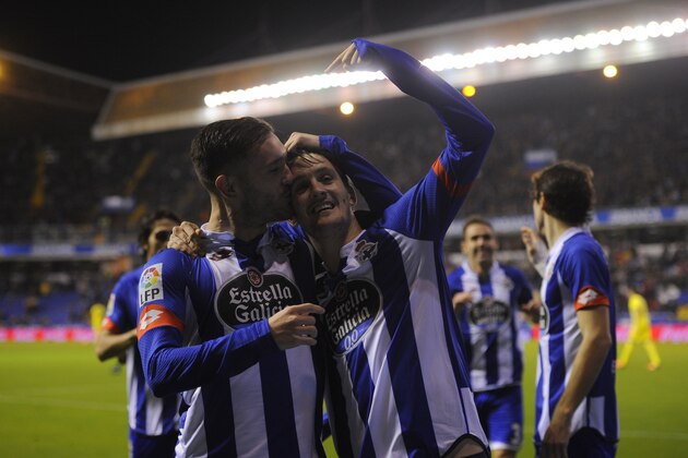 Deportivo La Coruna's midfielder Luis Alberto (R) celebrates with teammate midfielder Lucas Perez after scoring a goal during the Spanish league football match RC Deportivo de la Coruna vs Villarreal CF at the Municipal de Riazor stadium in La Coruna on January 3, 2016.   AFP PHOTO/ MIGUEL RIOPA / AFP / MIGUEL RIOPA        (Photo credit should read MIGUEL RIOPA/AFP/Getty Images)