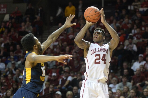Jan 16, 2016; Norman, OK, USA; Oklahoma Sooners guard Buddy Hield (24) shoots the ball in front of West Virginia Mountaineers guard Tarik Phillip (12) during the second half at Lloyd Noble Center. Mandatory Credit: Mark D. Smith-USA TODAY Sports