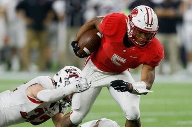 Katy running back Kyle Porter (5) is runs past Austin Lake Travis' Garrett Womack (32) during the Texas UIL 6A Division II state championship football game Saturday, Dec. 19, 2015, in Houston. Katy won 34-7. (AP Photo/Bob Levey)