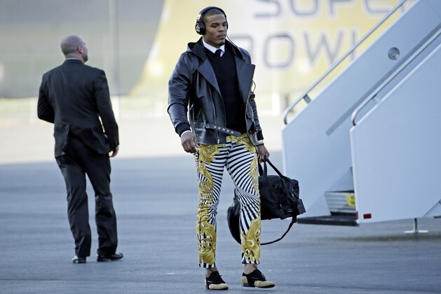 Carolina Panthers' Cam Newton gets off the plane at the Mineta San Jose International Airport as they arrive for the NFL Super Bowl football game Sunday, Jan. 31, 2016, in San Jose, Calif.  The Panthers play the Denver Broncos on Sunday, Feb. 7, 2015, in Super Bowl 50. (AP Photo/David J. Phillip)