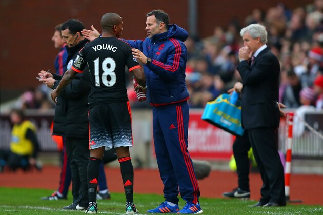 STOKE ON TRENT, ENGLAND - DECEMBER 26:  Ryan Giggs, assistant manager of Manchester United issues instructions to Ashley Young of Manchester United on the touchline as Mark Hughes, manager of Stoke City looks on during the Barclays Premier League match between Stoke City and Manchester United at Britannia Stadium on December 26, 2015 in Stoke on Trent, England.  (Photo by Dave Thompson/Getty Images)