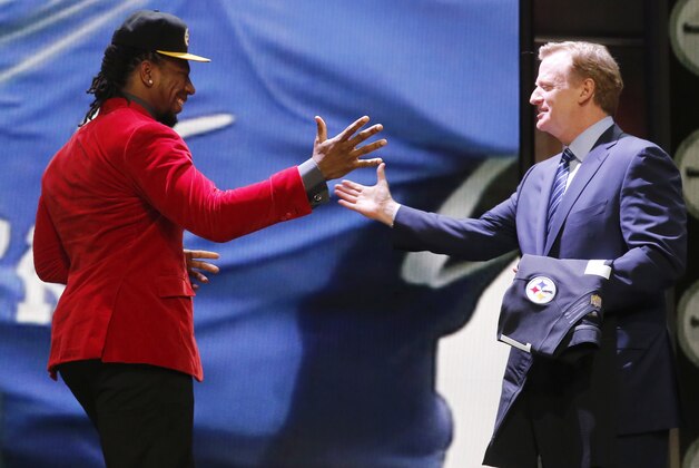 Kentucky linebacker Bud Dupree celebrates with NFL commissioner Roger Goodell after being selected by the Pittsburgh Steelers as the 22nd pick in the first round of the 2015 NFL Draft,  Thursday, April 30, 2015, in Chicago. (AP Photo/Charles Rex Arbogast)