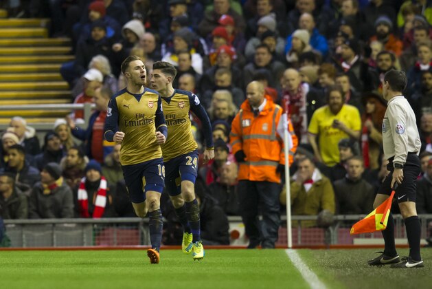 Arsenal's Aaron Ramsey, left, celebrates after scoring during the English Premier League soccer match between Liverpool and Arsenal at Anfield Stadium, Liverpool, England, Wednesday, Jan. 13, 2016. (AP Photo/Jon Super)