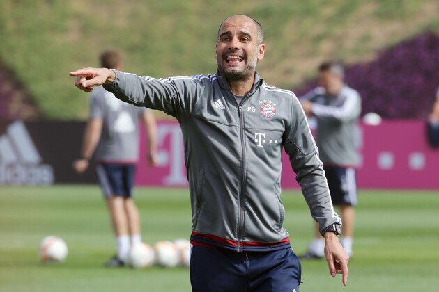Bayern Munich's Spanish head coach Pep Guardiola instructs his players during a training session as part of the team's winter training camp in the Qatari capital Doha on January 10, 2016.  / AFP / Karim JAAFAR        (Photo credit should read KARIM JAAFAR/AFP/Getty Images)