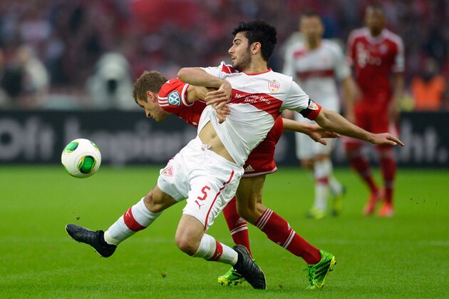 Bayern Munich's midfielder Thomas Mueller and Stuttgart's defender Serdar Tasci (front) vie for the ball during the final football match of the German Cup (DFB - Pokal) FC Bayern Munich vs VfB Stuttgart on June 1, 2013 in Berlin.    AFP PHOTO / ROBERT MICHAEL

RESTRICTIONS / EMBARGO - DFL LIMITS THE USE OF IMAGES ON THE INTERNET TO 15 PICTURES (NO VIDEO-LIKE SEQUENCES) DURING THE MATCH AND PROHIBITS MOBILE (MMS) USE DURING AND FOR FURTHER TWO HOURS AFTER THE MATCH. FOR MORE INFORMATION CONTACT DFL        (Photo credit should read ROBERT MICHAEL/AFP/Getty Images)