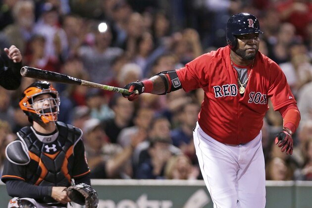 Boston Red Sox designated hitter David Ortiz, right, watches his two RBI double during the sixth inning of a baseball game against the Baltimore Orioles at Fenway Park in Boston, Friday, Sept. 25, 2015. At left is Orioles catcher Caleb Joseph. (AP Photo/Charles Krupa)
