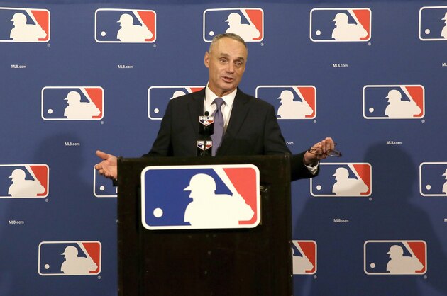FILE - In this Nov. 19, 2015, file photo, Major League Baseball Commissioner Rob Manfred speaks during a news conference after wrapping up the MLB owners meeting, in Dallas. On the anniversary of becoming baseball commissioner, Rob Manfred speaks with the AP and says it is possible the strike zone might be raised to the top of the knees.  (AP Photo/LM Otero, File)