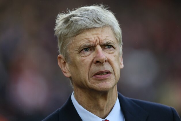 Arsenal manager Arsene Wenger looks across the pitch before the English Premier League soccer match between Southampton and Arsenal at St Mary's Stadium, Southampton, England, Thursday, Jan. 1, 2015. (AP Photo/Tim Ireland)