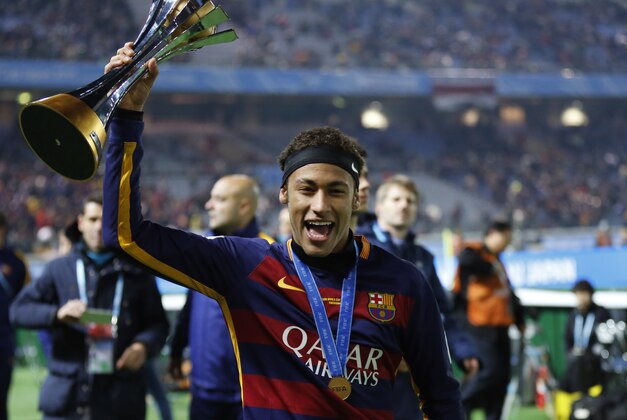 FC Barcelona's Neymar holds a trophy after winning the final match against River Plate at the FIFA Club World Cup soccer tournament in Yokohama, near Tokyo, Sunday, Dec. 20, 2015. (AP Photo/Shuji Kajiyama)