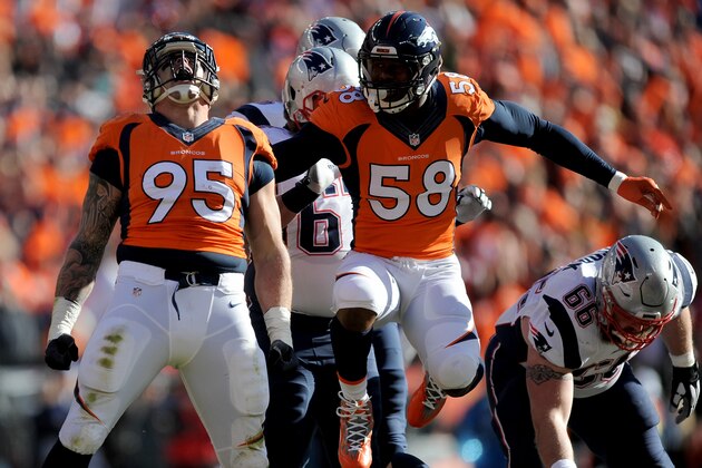 DENVER, CO - JANUARY 24:  Derek Wolfe #95 and  Von Miller #58 of the Denver Broncos react after a sack in the first half against the New England Patriots in the AFC Championship game at Sports Authority Field at Mile High on January 24, 2016 in Denver, Colorado.  (Photo by Dustin Bradford/Getty Images)